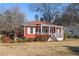 Charming single-story home featuring a welcoming front porch, red siding, and white trim at 318 Stewart Nw Ave, Marietta, GA 30064