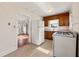 Functional kitchen featuring white appliances, wood cabinets, and a window with blinds at 318 Stewart Nw Ave, Marietta, GA 30064