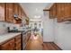 Functional kitchen with wood cabinets, stainless steel appliances, and a view into the adjacent dining area at 318 Stewart Nw Ave, Marietta, GA 30064