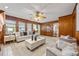 Living room with wood paneled walls, fireplace and built in shelving at 318 Stewart Nw Ave, Marietta, GA 30064