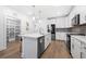 Well-lit kitchen with stainless steel appliances and ample counter space with view of pantry and front entrance at 3211 Orwell Way # 4302, Cumming, GA 30041