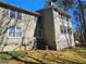 View of the back of house with screened in porch, painted siding, and an unfinished basement at 1409 Oakridge Cir, Decatur, GA 30033