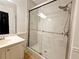 Recently renovated bathroom featuring a glass enclosed shower, and marble style tiling at 1409 Oakridge Cir, Decatur, GA 30033