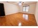 Spacious bedroom with hardwood floors, a ceiling fan, and natural light from window at 1409 Oakridge Cir, Decatur, GA 30033