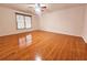 Spacious bedroom with hardwood floors, large window, and ceiling fan at 1409 Oakridge Cir, Decatur, GA 30033