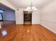 Formal dining room with hardwood flooring, elegant chandelier, and views into the kitchen at 1409 Oakridge Cir, Decatur, GA 30033