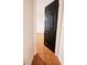 Hallway view of hardwood floors and a black paneled door leading into another room at 1409 Oakridge Cir, Decatur, GA 30033