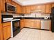 Traditional kitchen with black countertops, stainless steel appliances and light wood cabinets at 1409 Oakridge Cir, Decatur, GA 30033