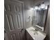 A bathroom featuring a sink, mirror, cabinet, and a modern lighting fixture at 926 Westland Dr, Marietta, GA 30064
