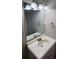 Bathroom sink with vanity has a stainless steel faucet, decorative lighting, and framed mirror at 926 Westland Dr, Marietta, GA 30064