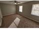 A spacious bedroom with neutral walls, two windows, and a ceiling fan for comfort at 926 Westland Dr, Marietta, GA 30064