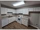 Well-lit kitchen featuring white cabinets, granite countertops, and new flooring at 926 Westland Dr, Marietta, GA 30064