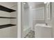 Well-lit bathroom featuring a bathtub, shelving, decorative flooring, and a modern vanity at 5380 Saint Lo Ln, Atlanta, GA 30349