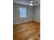 Bright bedroom with hardwood floors and neutral walls at 5380 Saint Lo Ln, Atlanta, GA 30349