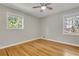 Cozy bedroom with hardwood floors and two bright windows at 5380 Saint Lo Ln, Atlanta, GA 30349