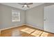 Bedroom showcasing hardwood floors, a window, and a door, creating a serene and comfortable space at 5380 Saint Lo Ln, Atlanta, GA 30349