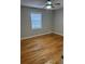 Well-lit bedroom featuring hardwood floors and ceiling fan at 5380 Saint Lo Ln, Atlanta, GA 30349