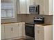 Modern kitchen with stainless steel appliances and white cabinets at 5380 Saint Lo Ln, Atlanta, GA 30349