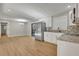 Open-concept kitchen featuring stainless steel appliances, white cabinets, and view into dining area at 5380 Saint Lo Ln, Atlanta, GA 30349