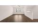 Bright living room with hardwood floors, ceiling fan, and large windows at 1009 Cades Walk, Lawrenceville, GA 30045