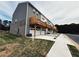 Rear exterior view of townhomes shows garages and wooden balconies with privacy fences at 1009 Cades Walk, Lawrenceville, GA 30045