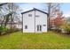 Backyard of modern white two-story home features a well-maintained lawn and minimalist architectural details at 1835 W Taylor Ave, East Point, GA 30344