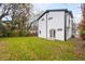 Backyard of modern white two-story home features a well-maintained lawn and minimalist architectural details at 1835 W Taylor Ave, East Point, GA 30344
