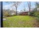 Spacious backyard surrounded by mature trees and lush greenery at 1835 W Taylor Ave, East Point, GA 30344