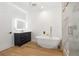 Modern bathroom with wood floors, stand alone tub, glass shower and custom vanity at 1835 W Taylor Ave, East Point, GA 30344