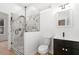 Modern bathroom with marble tiled shower and black vanity with undermount sink at 1835 W Taylor Ave, East Point, GA 30344