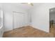 Bright bedroom with wood floors, ceiling fan, closet, and doorway at 1835 W Taylor Ave, East Point, GA 30344