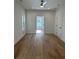 Bright bedroom featuring a ceiling fan, light hardwood floors, and a view to the doorway at 1835 W Taylor Ave, East Point, GA 30344