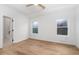 Bedroom with hardwood floors, two windows, and adjacent bathroom with marble tile at 1835 W Taylor Ave, East Point, GA 30344