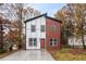 Modern two-story home with contrasting white and brown siding, sleek windows, and a freshly poured concrete driveway at 1835 W Taylor Ave, East Point, GA 30344