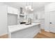A modern kitchen with white cabinets, marble countertops and backsplash, and stainless steel appliances at 1835 W Taylor Ave, East Point, GA 30344