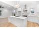 Modern kitchen featuring white cabinets, quartz countertops, and a large island at 1835 W Taylor Ave, East Point, GA 30344
