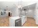 Kitchen island with white cabinets, marble countertop, and stainless steel appliances in an open concept home at 1835 W Taylor Ave, East Point, GA 30344