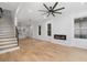 Light-filled living room with hardwood floors, fireplace, and modern ceiling fan at 1835 W Taylor Ave, East Point, GA 30344