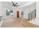 Spacious living room boasts wood floors, a sleek fireplace, and natural light from multiple windows at 1835 W Taylor Ave, East Point, GA 30344