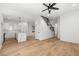 Living room with staircase and kitchen with white cabinets, marble countertops and stainless steel appliances at 1835 W Taylor Ave, East Point, GA 30344