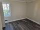 Spacious bedroom with gray vinyl flooring and a window at 5312 Westford Cir, Atlanta, GA 30349