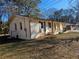 Side view of charming Ranch home showcasing new paint and landscaping at 5312 Westford Cir, Atlanta, GA 30349