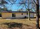 Backyard view of a house with patio and trees at 5312 Westford Cir, Atlanta, GA 30349