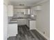 Modern kitchen featuring white cabinets, granite countertops, and vinyl flooring at 5312 Westford Cir, Atlanta, GA 30349