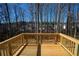 A spacious wooden back deck surrounded by tall trees and nature at 101 Azalea Dr, Villa Rica, GA 30180