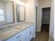 Bathroom with double sink vanity, granite counters, and brushed nickel lighting and hardware at 101 Azalea Dr, Villa Rica, GA 30180