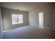Bedroom offers a neutral color palette and a window offering plenty of natural light at 101 Azalea Dr, Villa Rica, GA 30180