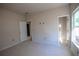 Bright bedroom features neutral walls, white trim, and natural light from a window at 101 Azalea Dr, Villa Rica, GA 30180