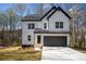 Charming two-story modern farmhouse with white siding, black trim, and a two-car garage at 101 Azalea Dr, Villa Rica, GA 30180