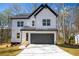Charming two-story modern farmhouse with white siding, black trim, and a two-car garage at 101 Azalea Dr, Villa Rica, GA 30180